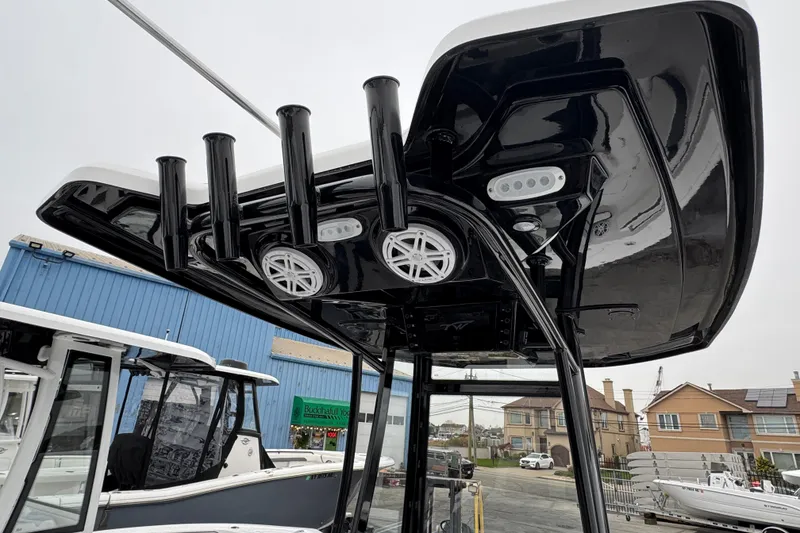 Slide: The Image of 2026 Tidewater 210 CC Adventure boat with sleek black T-top and rod holders. - 6