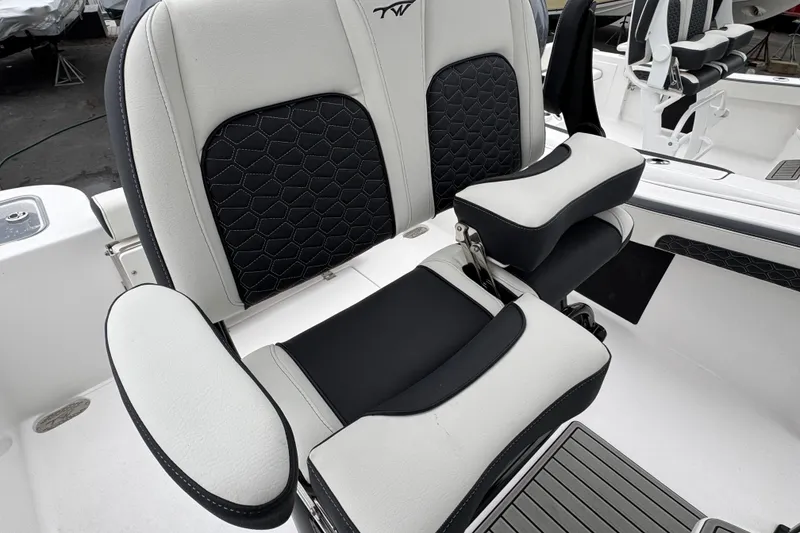 Slide: The Image of 2026 Tidewater 210 CC Adventure boat seat with black and white cushioned design. - 7