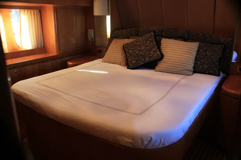 Slide: The Image of Luxurious bedroom interior of 2004 Horizon P70 yacht with elegant bedding and warm lighting. - 17