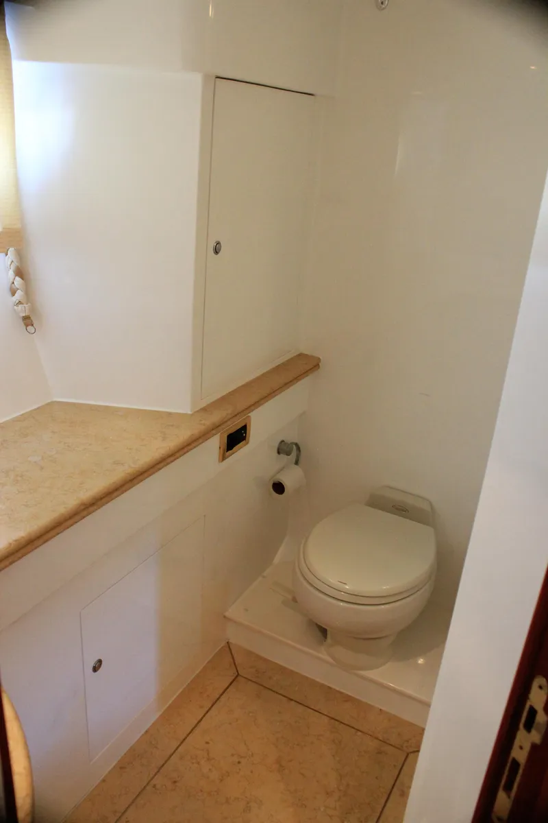 Slide: The Image of Compact bathroom in 2004 Horizon P70 yacht with modern fixtures and beige countertop. - 19