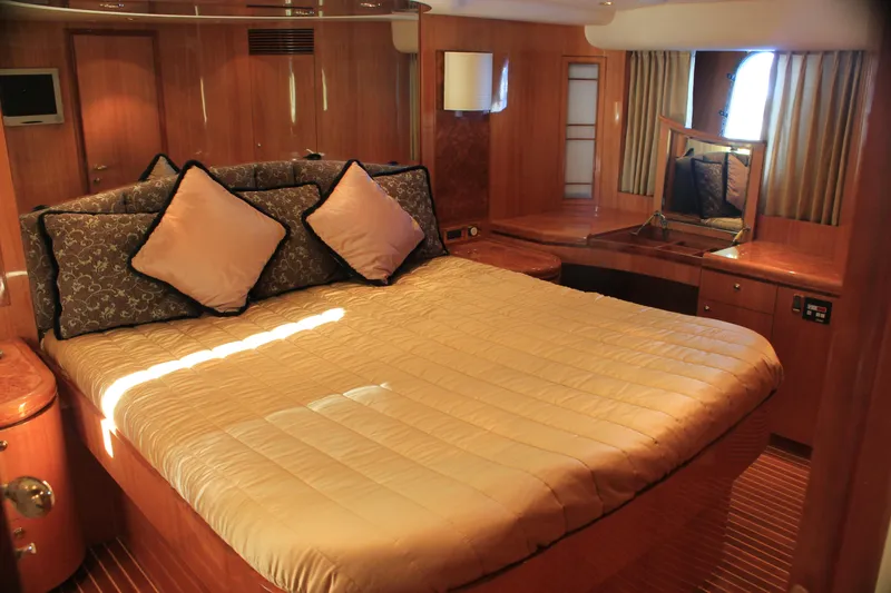 Slide: The Image of Luxurious cabin interior of 2004 Horizon P70 yacht with plush bedding and wooden accents. - 32