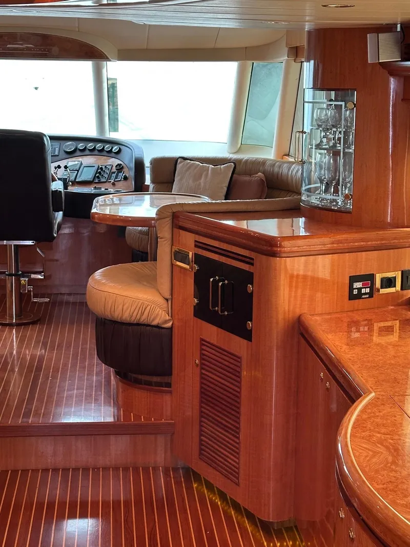 Slide: The Image of Luxurious 2004 Horizon P70 yacht interior with polished wood and plush seating. - 6