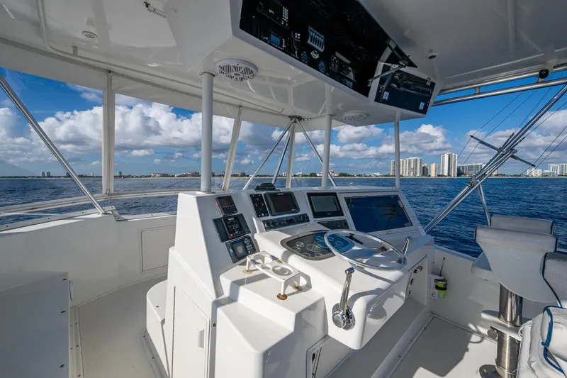 Slide: The Image of 1998 Viking 50 Convertible yacht helm with ocean view and city skyline in background. - 15