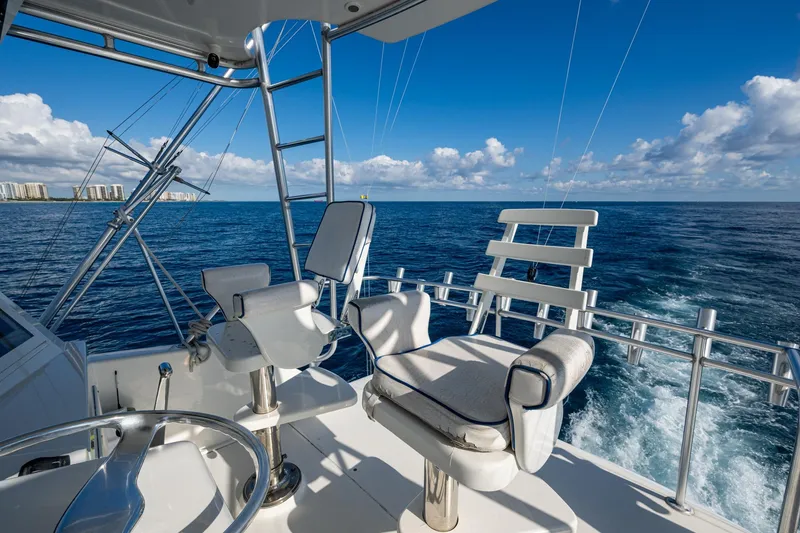 Slide: The Image of 1998 Viking 50 Convertible yacht helm with ocean view and clear blue sky. - 16