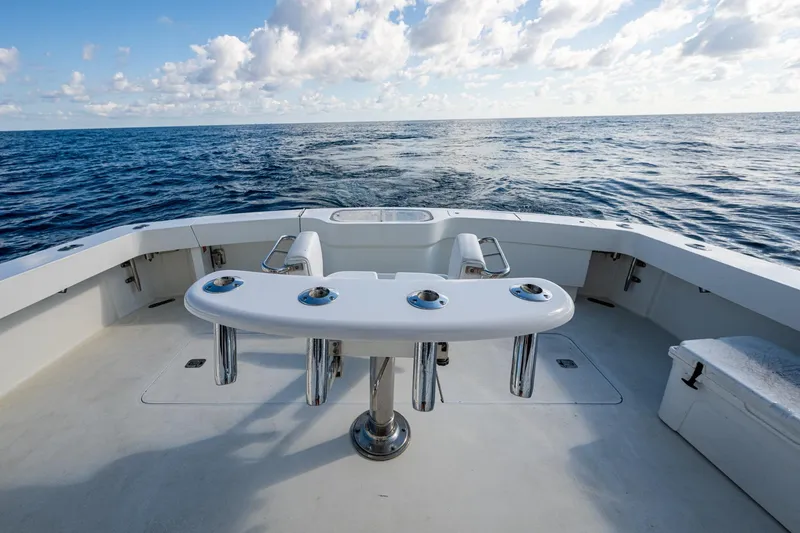 Slide: The Image of 1998 Viking 50 Convertible yacht deck with ocean view and fishing rod holders. - 21