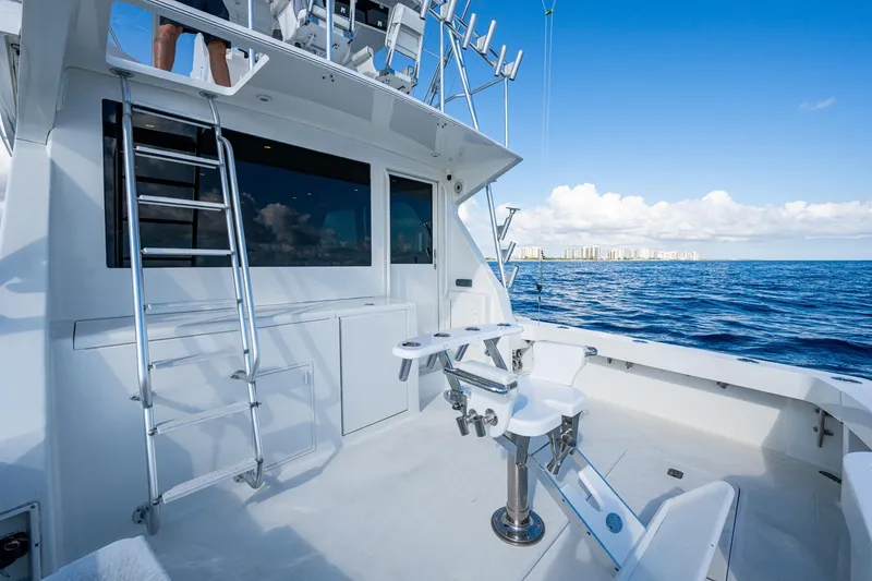 Slide: The Image of 1998 Viking 50 Convertible yacht deck with fishing chair, ladder, and ocean view. - 22