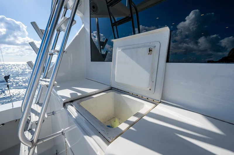 Slide: The Image of Open hatch on 1998 Viking 50 Convertible yacht deck, ocean view in background. - 26