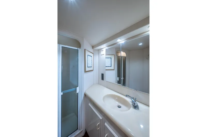 Slide: The Image of Bathroom interior of 1998 Viking 50 Convertible yacht with sink and shower. - 38