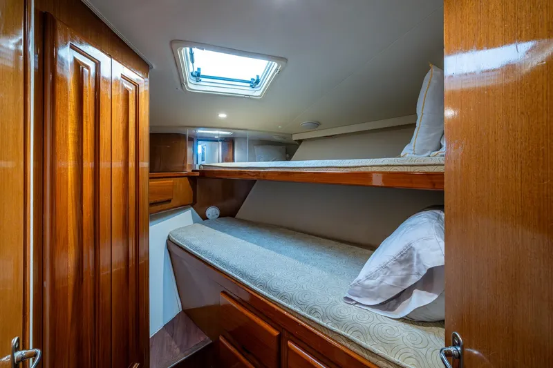 Slide: The Image of 1998 Viking 50 Convertible yacht cabin with wooden interior and bunk beds. - 39