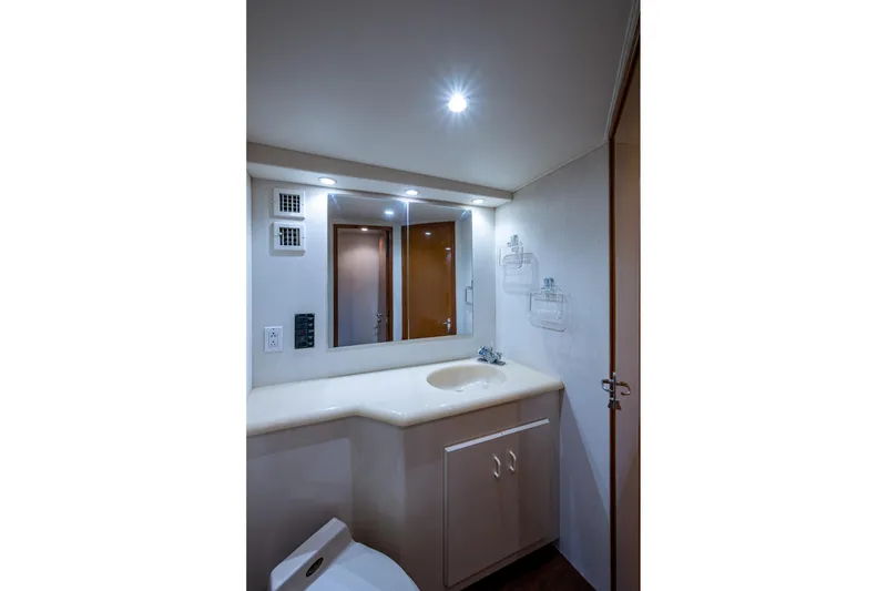Slide: The Image of Bathroom interior of 1998 Viking 50 Convertible yacht, featuring sink and mirror. - 42
