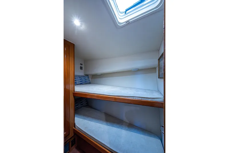 Slide: The Image of 1998 Viking 50 Convertible yacht interior with bunk beds and skylight. - 43
