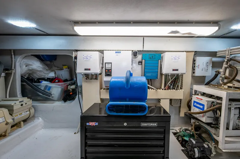 Slide: The Image of Engine room of 1998 Viking 50 Convertible yacht with equipment and storage. - 49