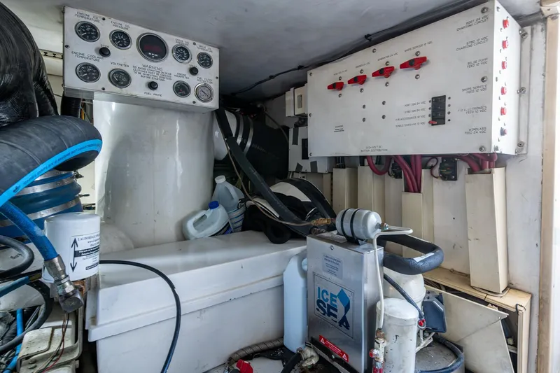 Slide: The Image of Engine room of 1998 Viking 50 Convertible boat with control panels and equipment. - 51