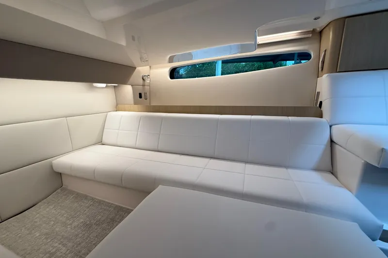 Slide: The Image of Luxurious interior of 2026 Regal 36 Grande Coupe with white seating and modern design. - 100