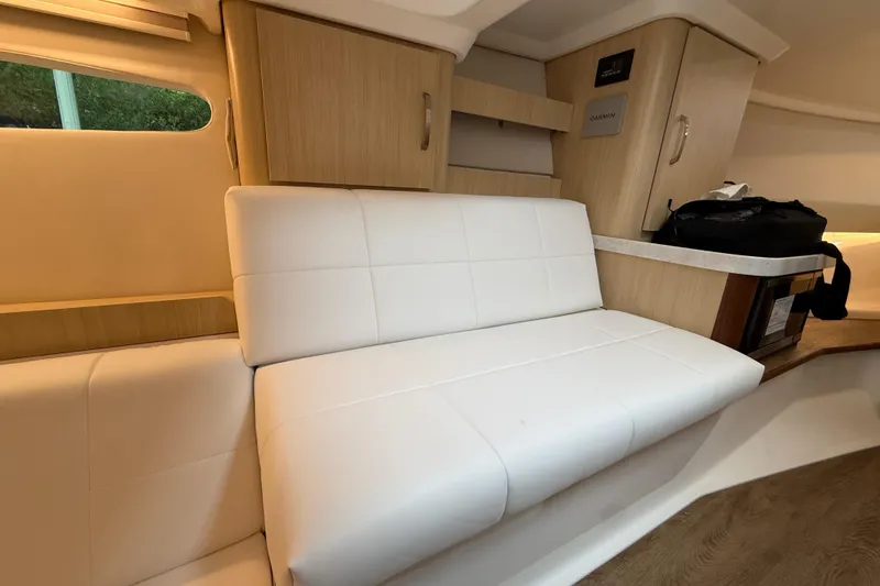 Slide: The Image of Interior of 2026 Regal 36 Grande Coupe with white seating and wooden cabinetry. - 101