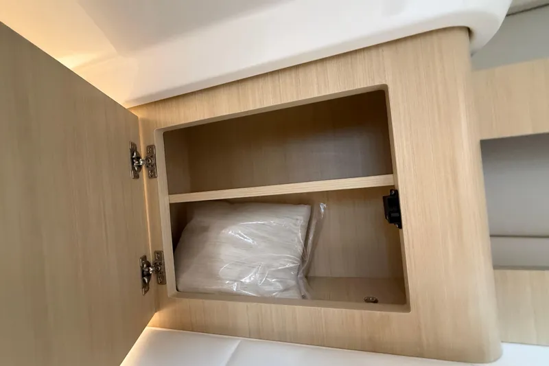 Slide: The Image of Open wooden cabinet in 2026 Regal 36 Grande Coupe boat interior. - 102