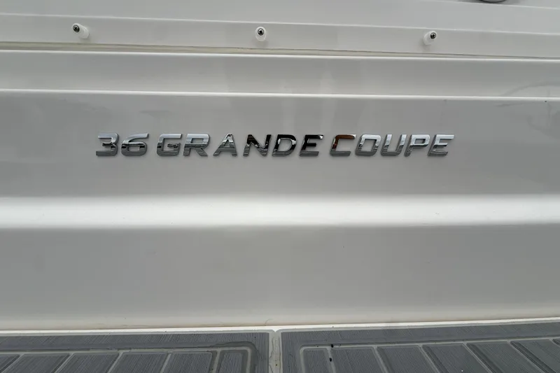 Slide: The Image of 2026 Regal 36 Grande Coupe boat nameplate on white surface. - 11