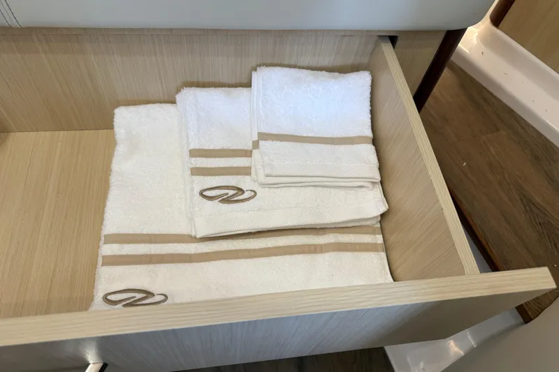Slide: The Image of Luxury towels in a drawer of the 2026 Regal 36 Grande Coupe yacht. - 115