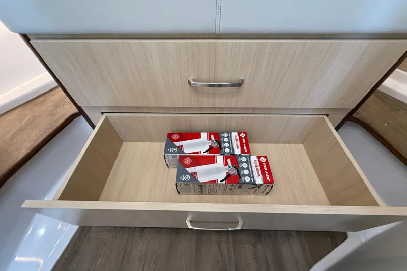 Slide: The Image of Open drawer in 2026 Regal 36 Grande Coupe with fire extinguishers inside. - 116