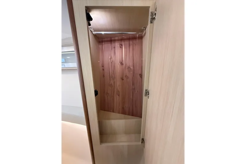 Slide: The Image of Interior view of 2026 Regal 36 Grande Coupe wooden cabinet with open door. - 117