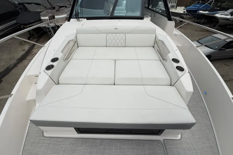 Slide: The Image of 2026 Regal 36 Grande Coupe boat with luxurious white seating and cup holders. - 121