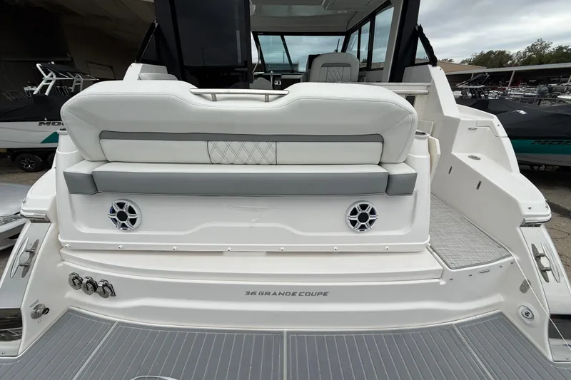 Slide: The Image of 2026 Regal 36 Grande Coupe boat, rear view with seating and speakers. - 13