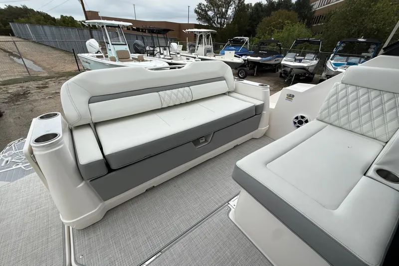 Slide: The Image of 2026 Regal 36 Grande Coupe boat interior with luxurious seating and cup holders. - 21
