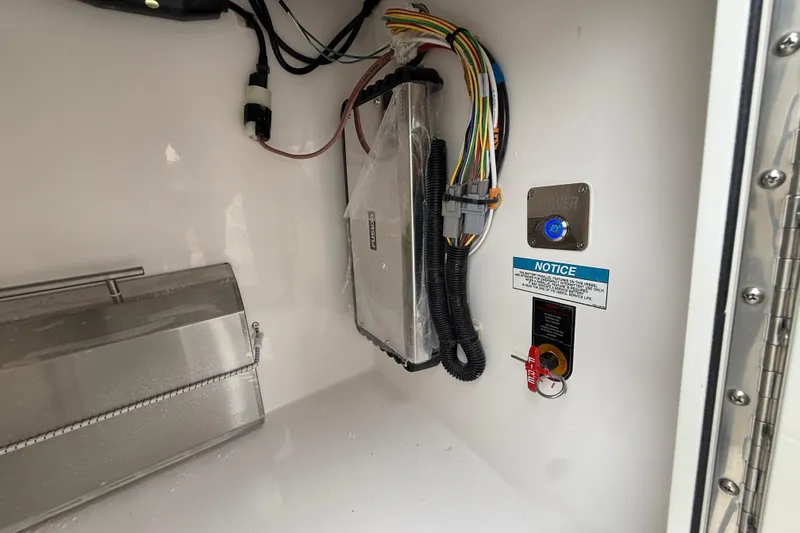 Slide: The Image of Electrical compartment of 2026 Regal 36 Grande Coupe with wiring and control panel. - 27