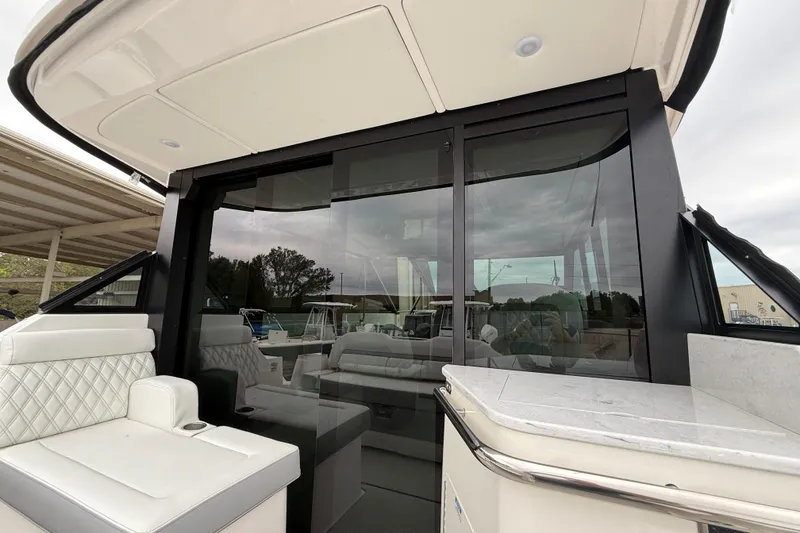 Slide: The Image of 2026 Regal 36 Grande Coupe interior with luxurious seating and sleek glass doors. - 28