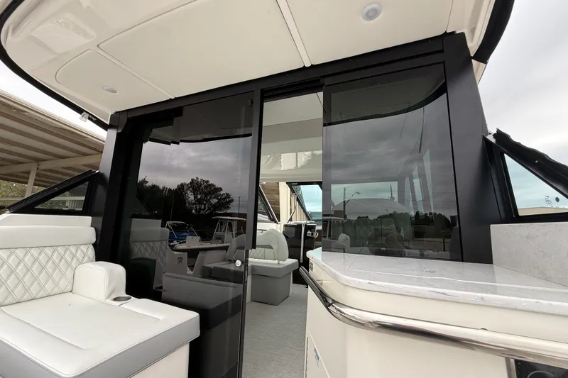 Slide: The Image of 2026 Regal 36 Grande Coupe yacht interior with sleek seating and modern design. - 29