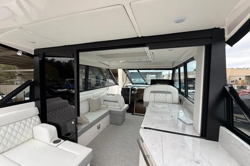 Slide: The Image of Luxurious interior of 2026 Regal 36 Grande Coupe yacht with elegant seating and modern design. - 31
