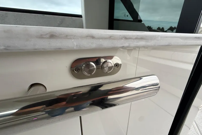 Slide: The Image of Close-up of 2026 Regal 36 Grande Coupe yacht interior detail with buttons and chrome handle. - 32