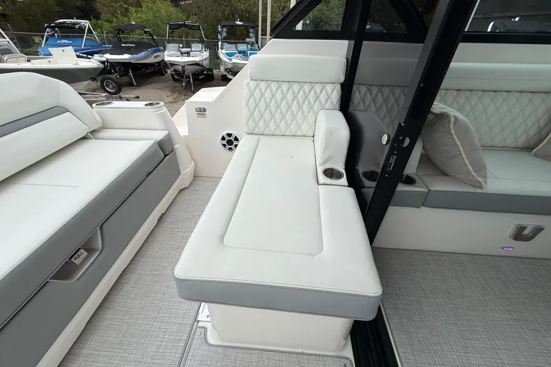 Slide: The Image of Luxurious seating on 2026 Regal 36 Grande Coupe boat, featuring elegant upholstery and cup holders. - 33