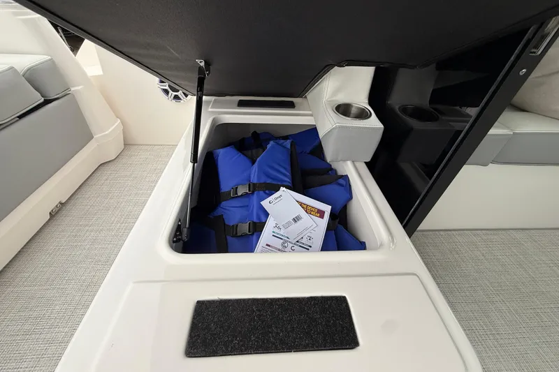 Slide: The Image of Storage compartment with life jackets on a 2026 Regal 36 Grande Coupe boat. - 34