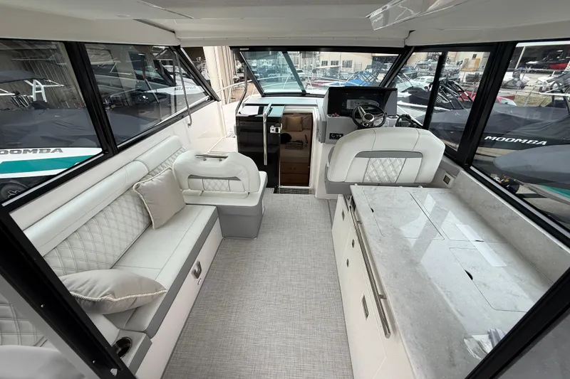 Slide: The Image of Luxurious interior of 2026 Regal 36 Grande Coupe yacht with elegant seating and helm. - 35