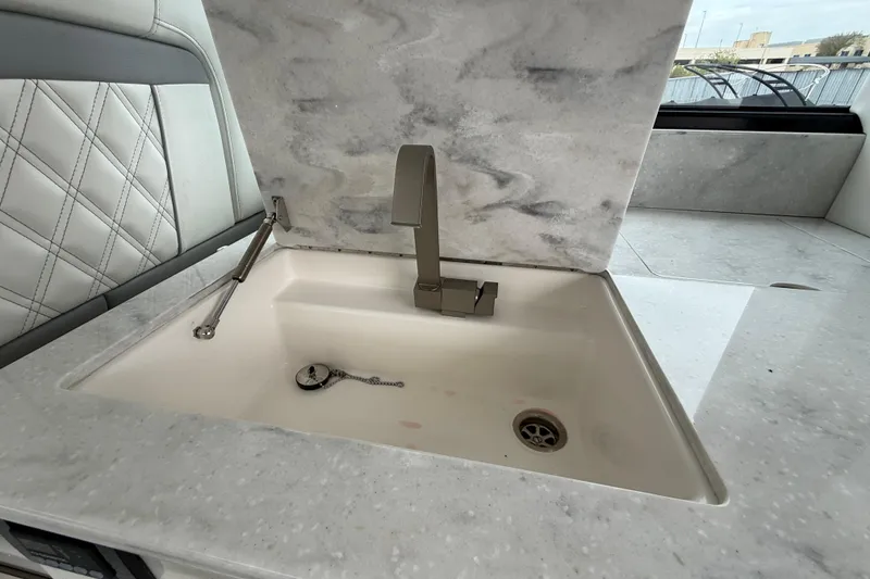 Slide: The Image of Luxury sink in 2026 Regal 36 Grande Coupe yacht with modern faucet and marble countertop. - 37