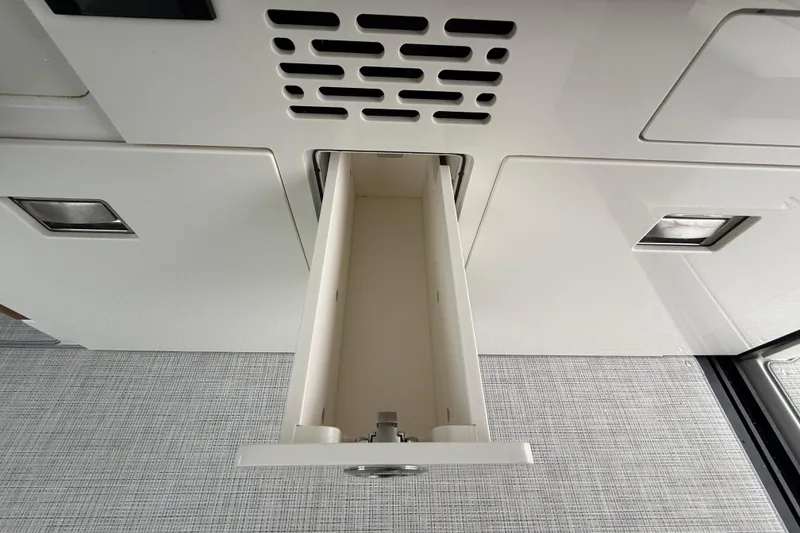 Slide: The Image of Open storage compartment in 2026 Regal 36 Grande Coupe interior. - 43