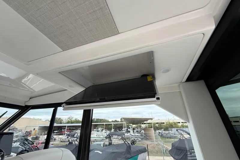 Slide: The Image of Interior view of 2026 Regal 36 Grande Coupe with a retractable TV screen. - 47