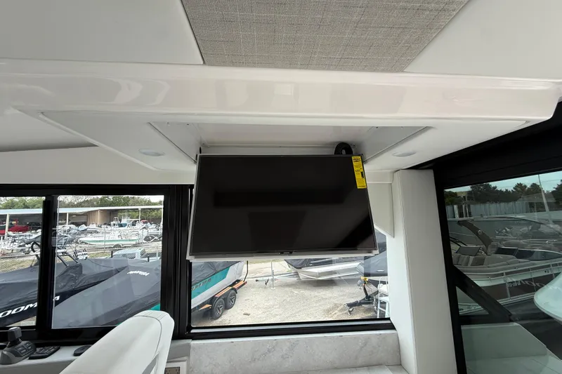 Slide: The Image of Interior of 2026 Regal 36 Grande Coupe with mounted TV and marina view. - 48