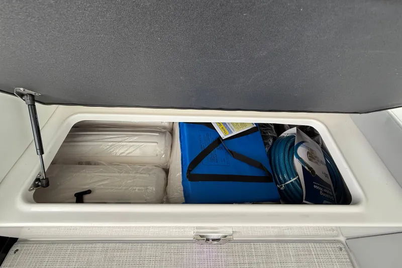 Slide: The Image of Storage compartment in 2026 Regal 36 Grande Coupe with hose and blue bag. - 52