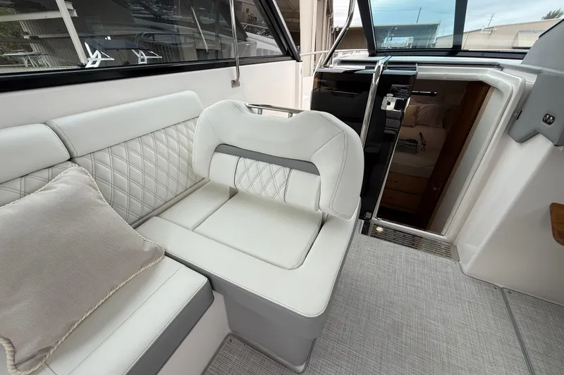 Slide: The Image of Luxurious interior of 2026 Regal 36 Grande Coupe yacht with elegant seating and cabin entrance. - 53