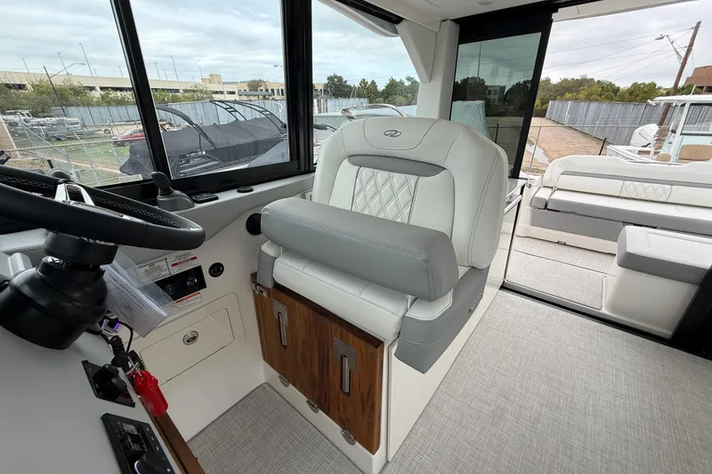 Slide: The Image of Interior of 2026 Regal 36 Grande Coupe, featuring luxurious seating and modern helm design. - 55