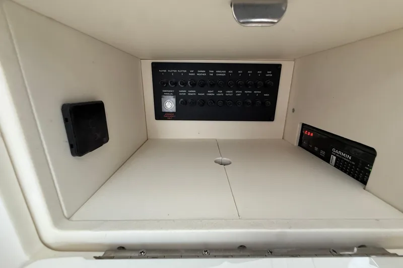 Slide: The Image of Control panel inside 2026 Regal 36 Grande Coupe, featuring switches and Garmin electronics. - 61