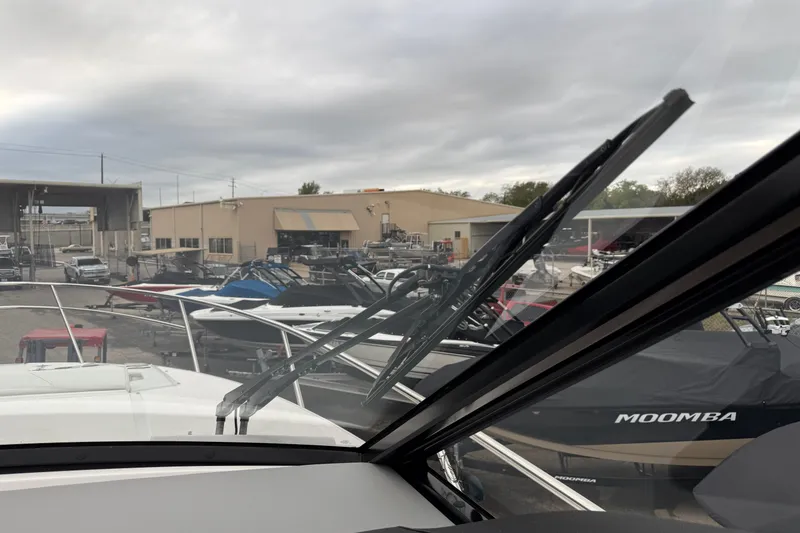 Slide: The Image of 2026 Regal 36 Grande Coupe at a marina with boats and overcast sky. - 69