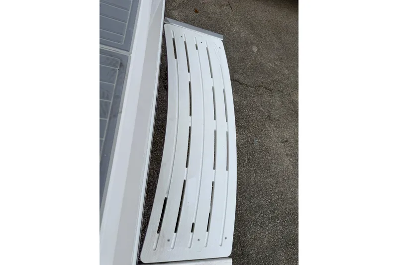 Slide: The Image of 2026 Regal 36 Grande Coupe boat deck detail, featuring a white slatted design. - 7