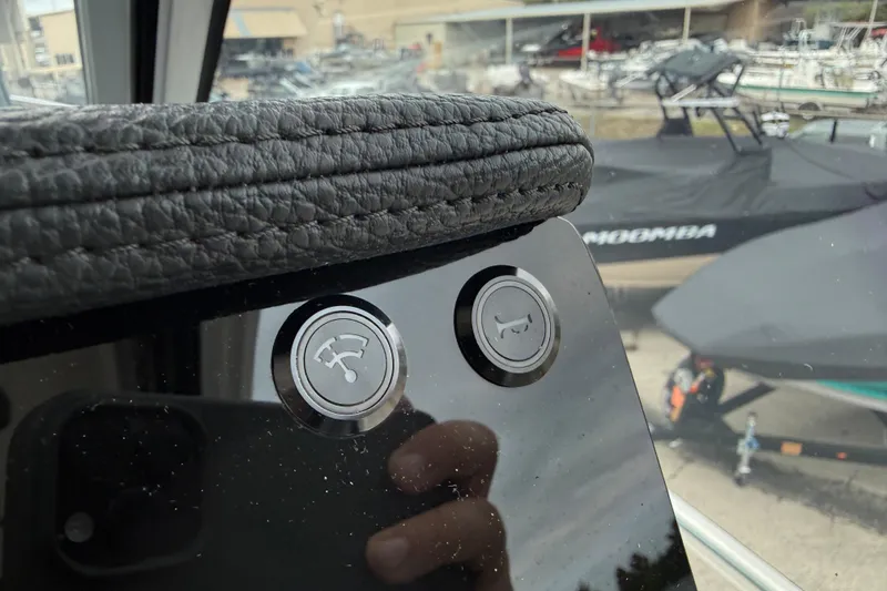 Slide: The Image of Close-up of control buttons on 2026 Regal 36 Grande Coupe boat dashboard. - 70