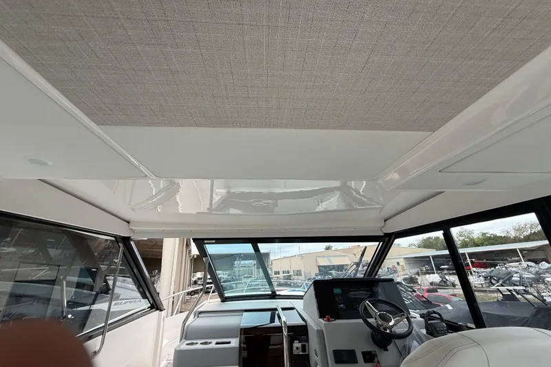 Slide: The Image of Interior view of 2026 Regal 36 Grande Coupe yacht cockpit with modern steering and controls. - 74