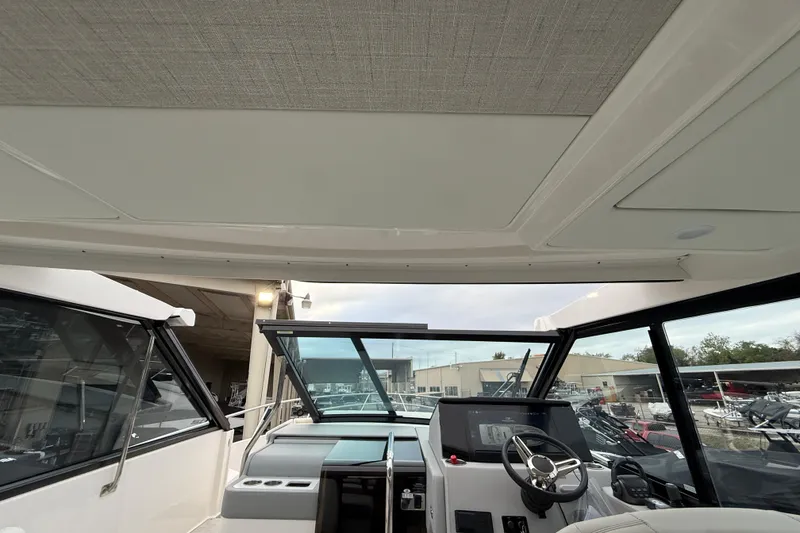 Slide: The Image of Interior view of 2026 Regal 36 Grande Coupe yacht cockpit with modern controls. - 75