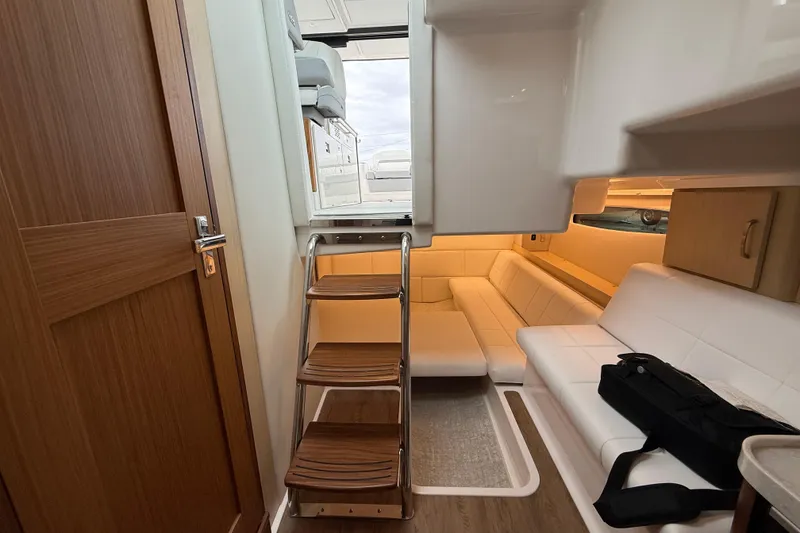 Slide: The Image of Interior of 2026 Regal 36 Grande Coupe yacht with modern seating and wooden accents. - 78