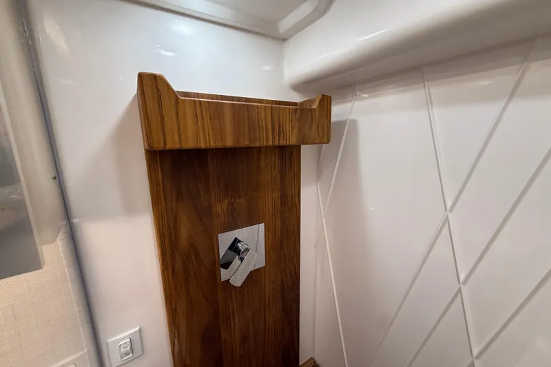 Slide: The Image of Interior detail of 2026 Regal 36 Grande Coupe, featuring wood paneling and modern design elements. - 82